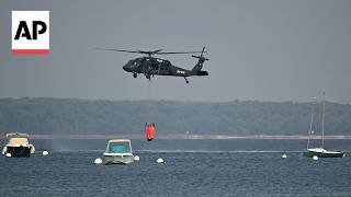 Helicopters collect seawater to aid battle against wildfires in France