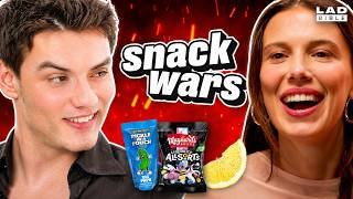 Millie Bobby Brown & Louis Partridge Go Head To Head In The Ultimate Snack Wars: Showdown