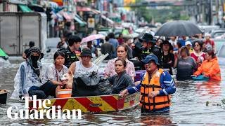 Bangkok residents navigate streets by boat as flood waters rise