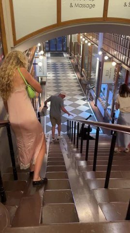 Woman Falls on Stairs While Sliding Down Handrail