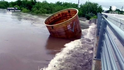 Debris slams bridge during life-threatening Texas flood