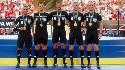 Match official goes viral after being caught on tiptoes in World Cup final group photo